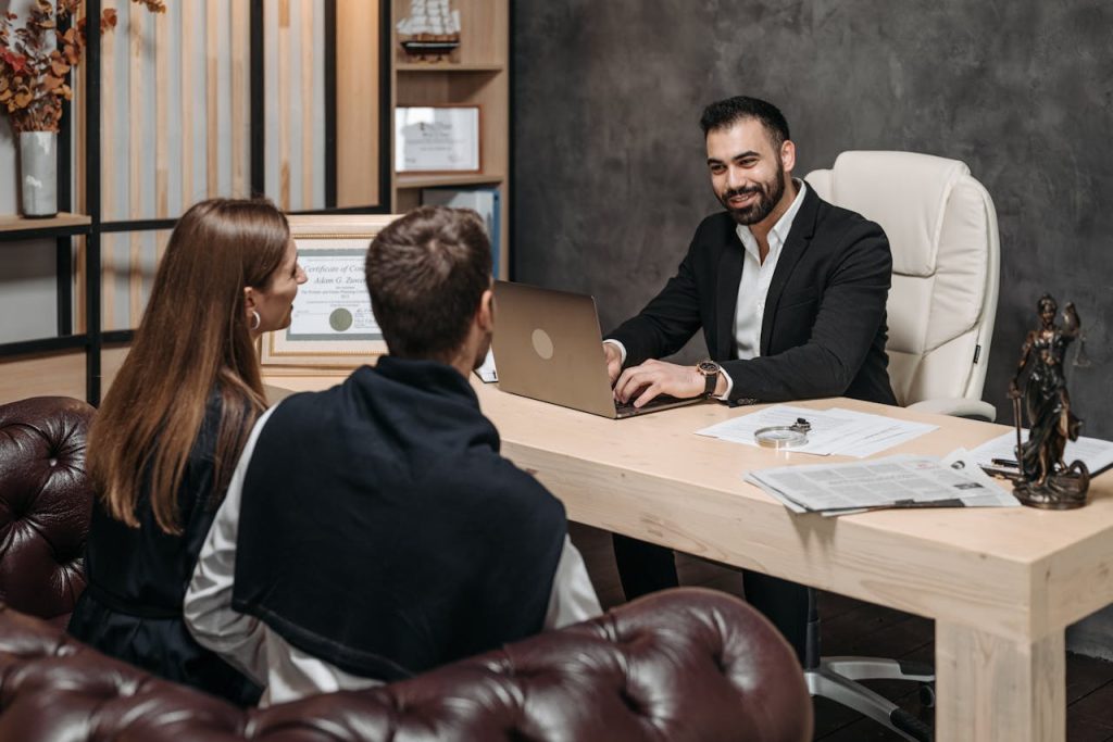 pexels photo 8112164 A professional meeting with a lawyer consulting clients in an upscale office environment.